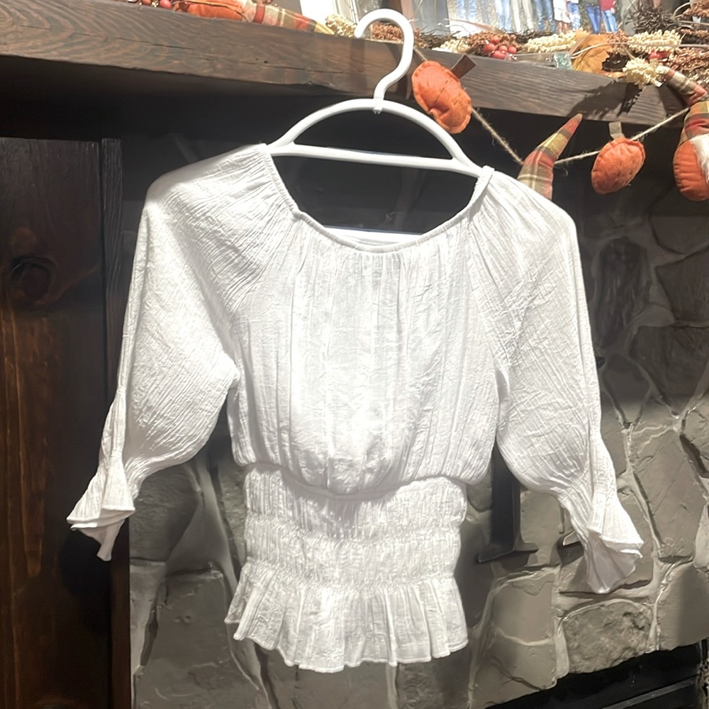 White, ruffle top for girls.